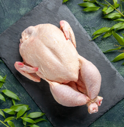 Raw chicken pieces arranged on tray